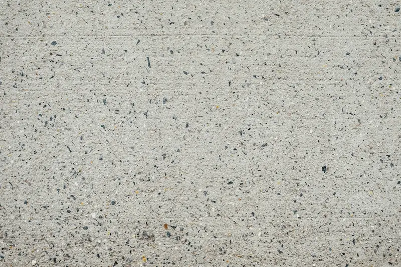 Surface de béton vue de près, petits gravillons apparents